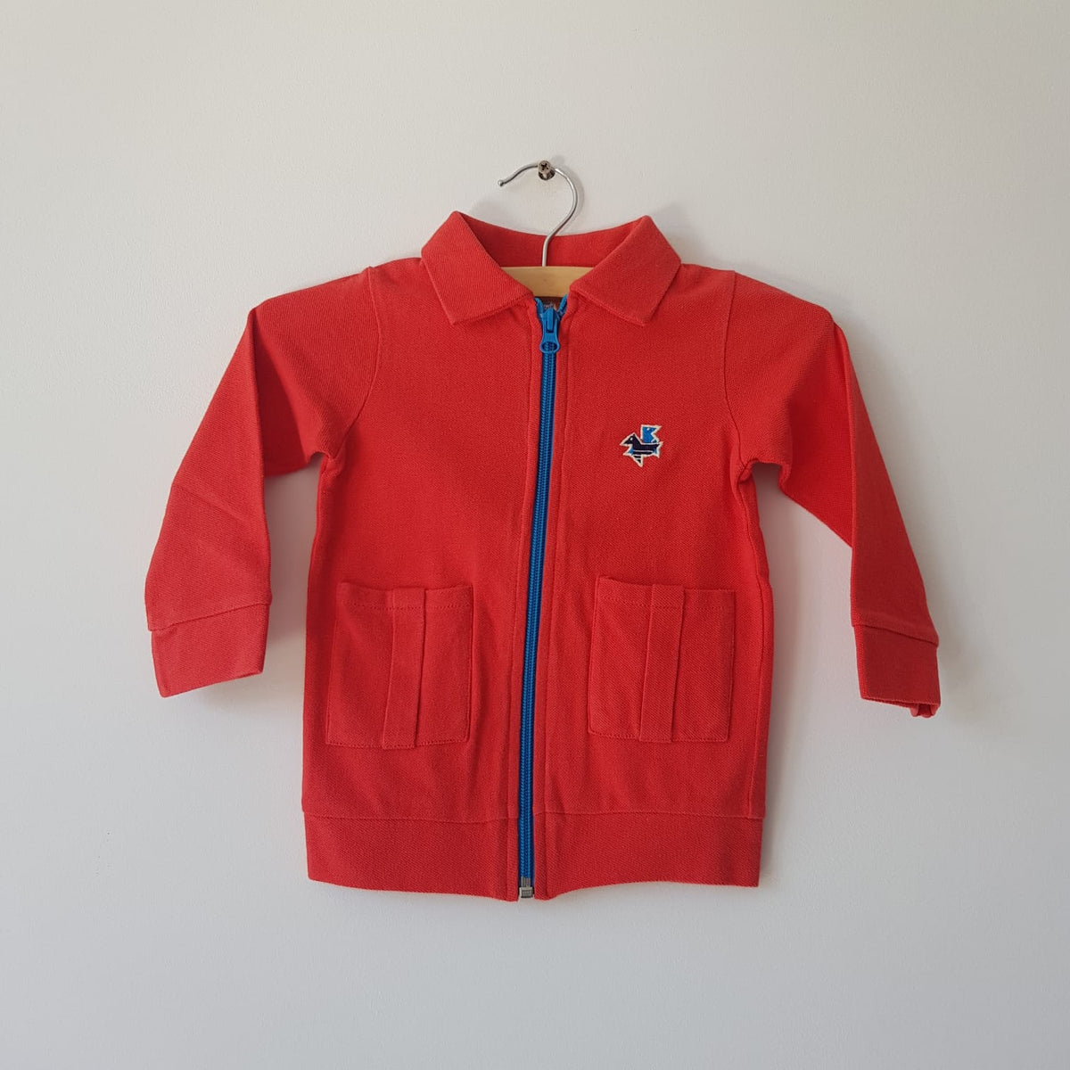 This is a Color - Vest Red Polo Blue Zipper Two Pockets Blue Birds - Vest Red with Blue Zipper